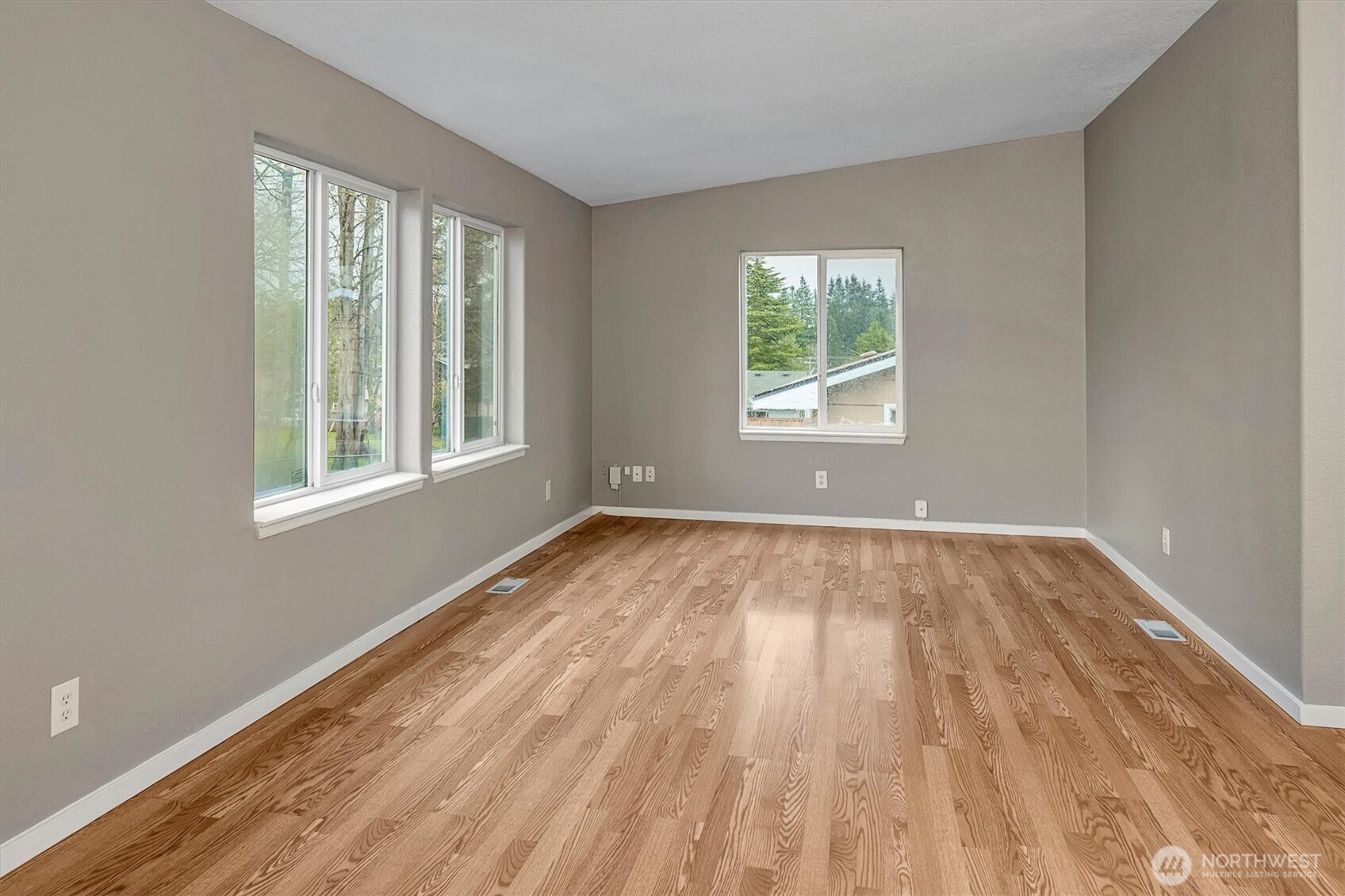 6407 Cady Road, Unit C Everett, WA 98203 - Photo 5 of 27 a view of an empty room with wooden floor and a window