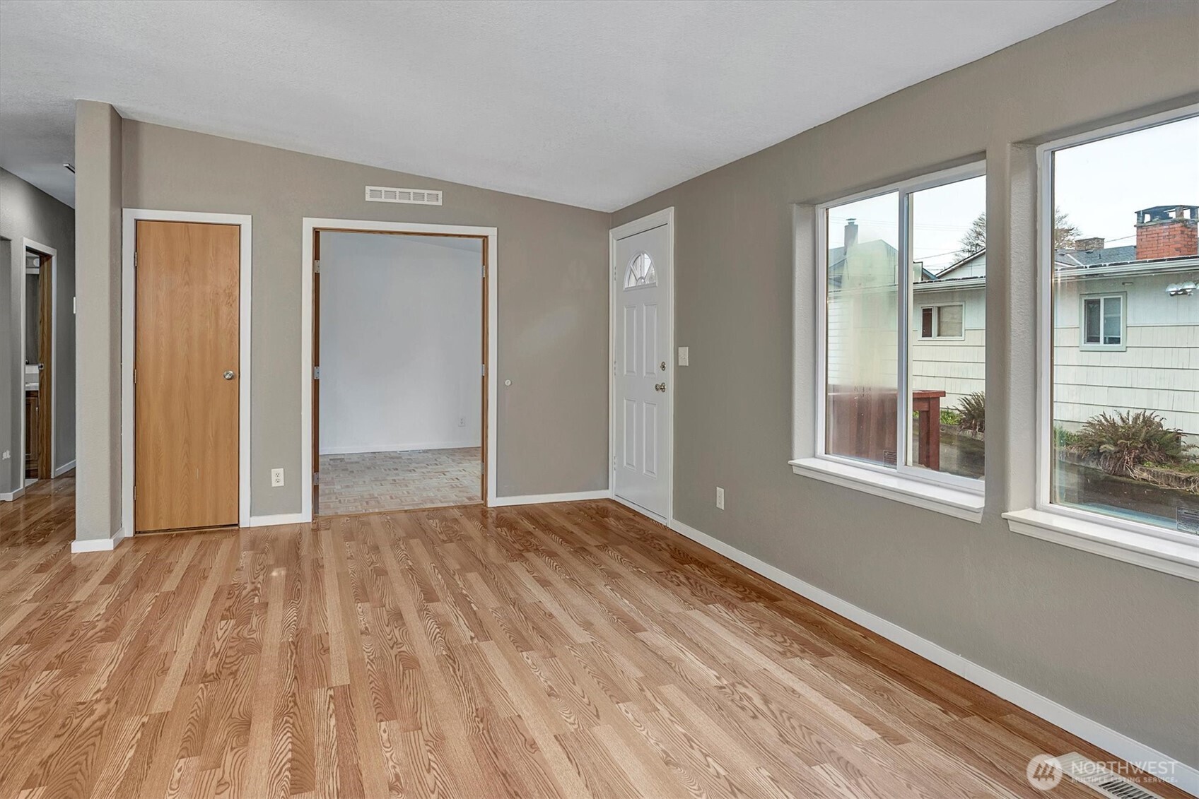 6407 Cady Road, Unit C Everett, WA 98203 - Photo 7 of 27 a view of an empty room with wooden floor and a window