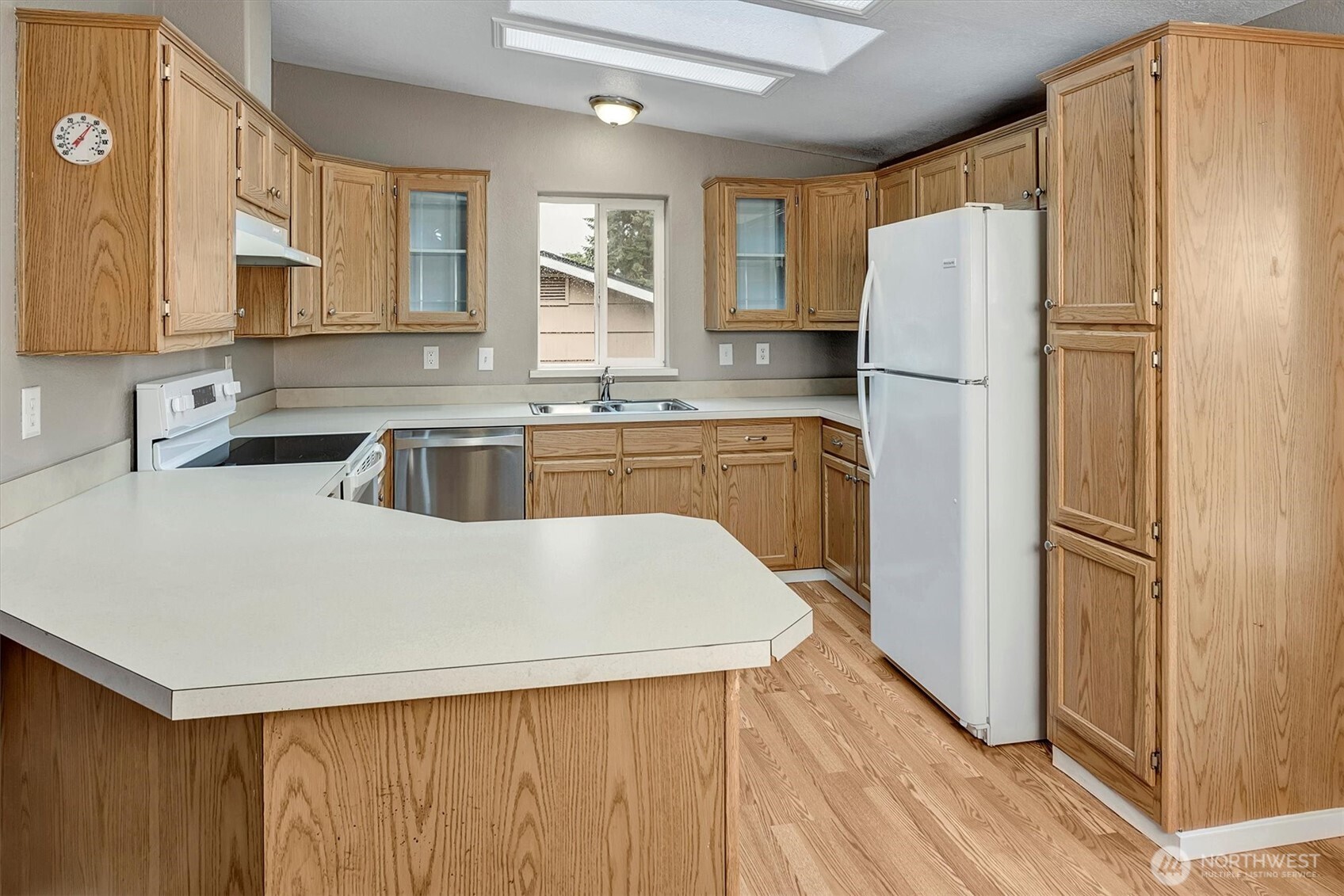 6407 Cady Road, Unit C Everett, WA 98203 - Photo 10 of 27 a kitchen with a refrigerator a sink and cabinets