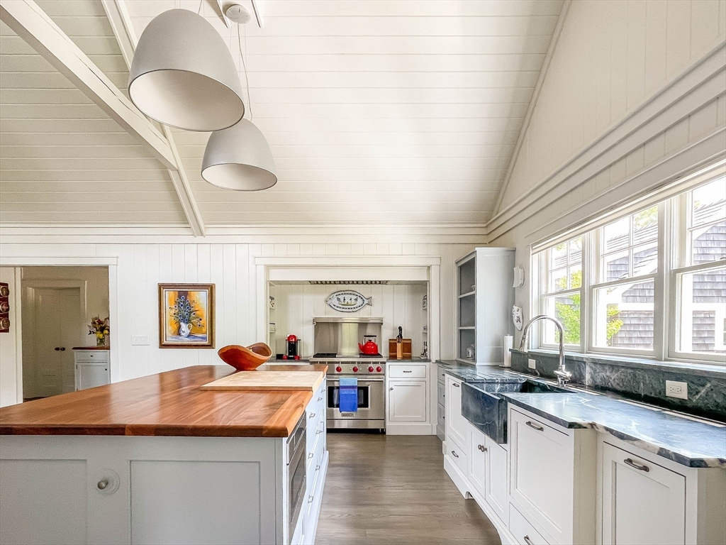 149 Litchfield Road Edgartown, MA 02539 - Photo 17 of 37 a kitchen with granite countertop a sink stainless steel appliances and cabinets