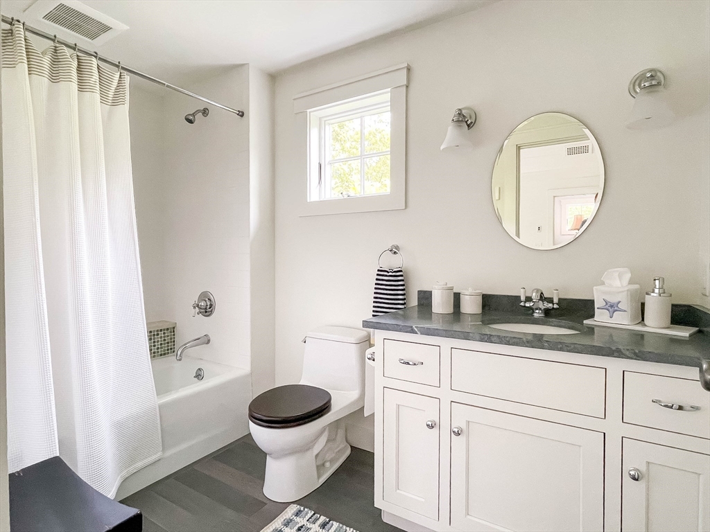 149 Litchfield Road Edgartown, MA 02539 - Photo 28 of 37 a bathroom with a granite countertop sink toilet a mirror and shower