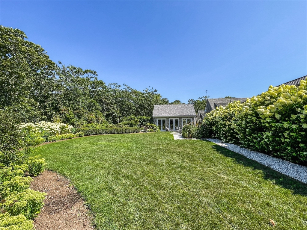 149 Litchfield Road Edgartown, MA 02539 - Photo 30 of 37 a view of a backyard with plants and a garden
