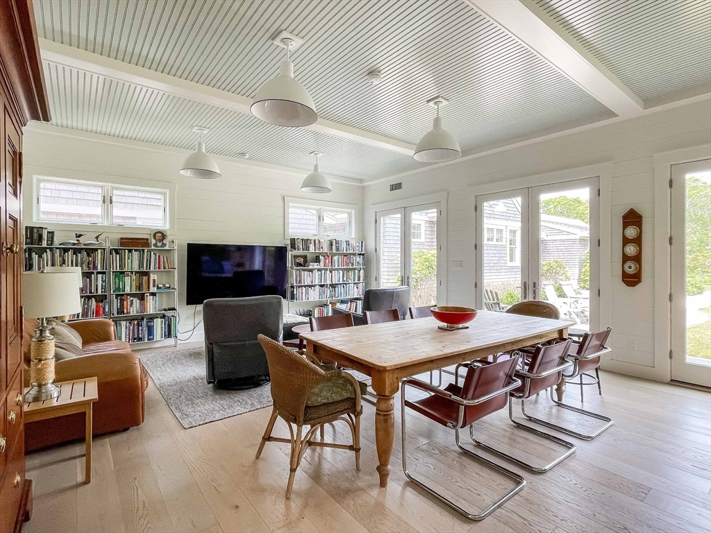 149 Litchfield Road Edgartown, MA 02539 - Photo 31 of 37 a dining room with a wooden table and chairs