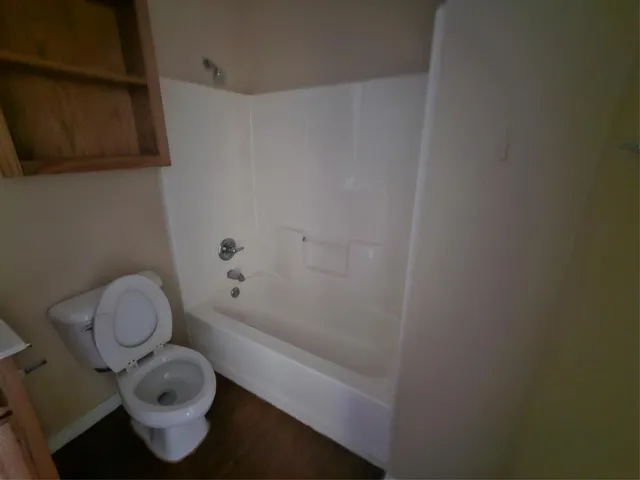 a bathroom with a toilet and a shower