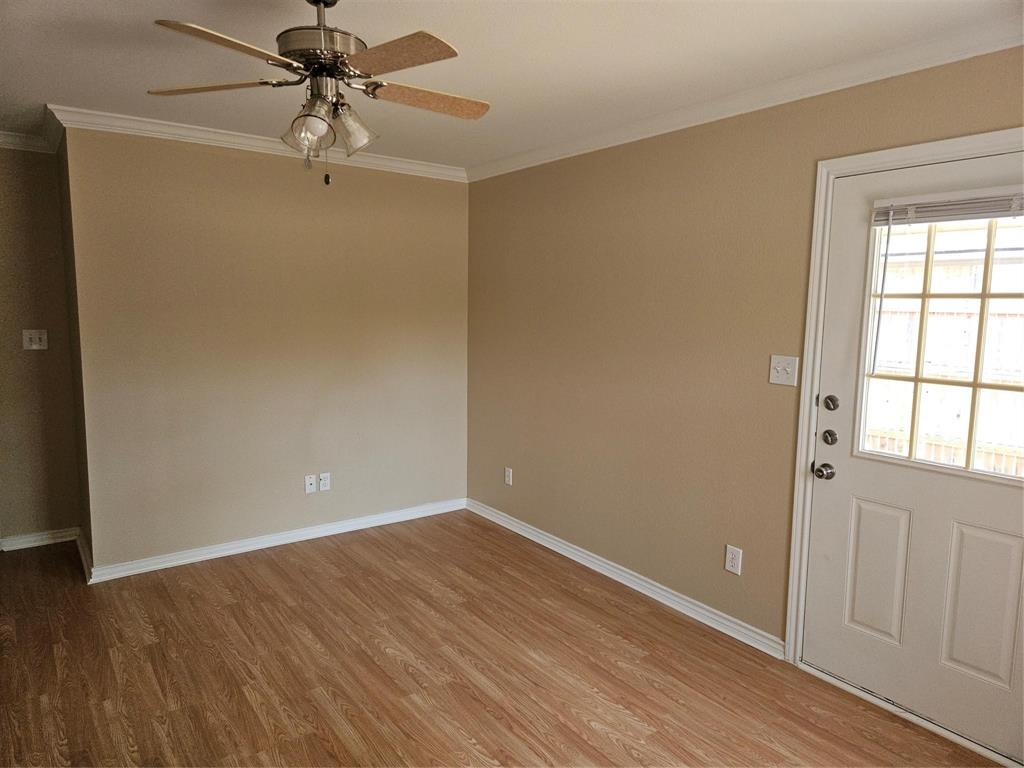 1605 Stuart Road Denton, TX 76209 - Photo 16 of 22 a view of an empty room with wooden floor and a window