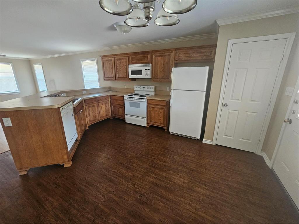1605 Stuart Road Denton, TX 76209 - Photo 6 of 22 a kitchen with a refrigerator a stove top oven a sink and dishwasher