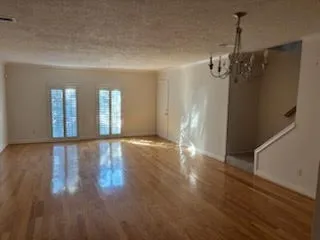 a view of a room with wooden floor and balcony