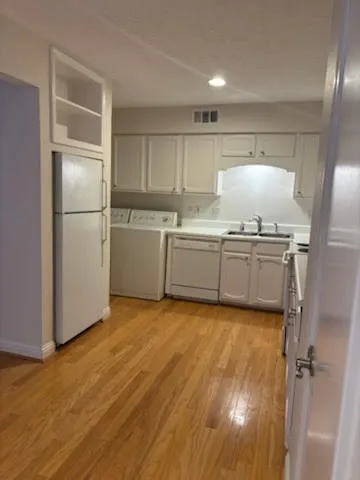 a kitchen with stainless steel appliances granite countertop a refrigerator and a stove