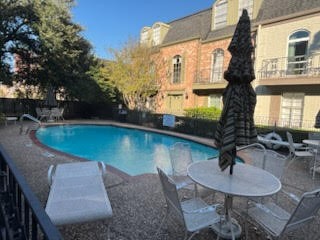 535 North Post Oak Lane, Unit 535 Houston, TX 77024 - Photo 6 of 12 a swimming pool with some trees in the background