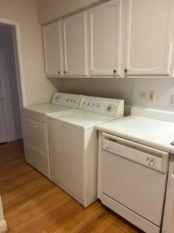a bath tub sitting next to a white sink and vanity