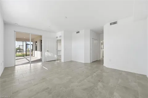 a open kitchen with white cabinets and white appliances