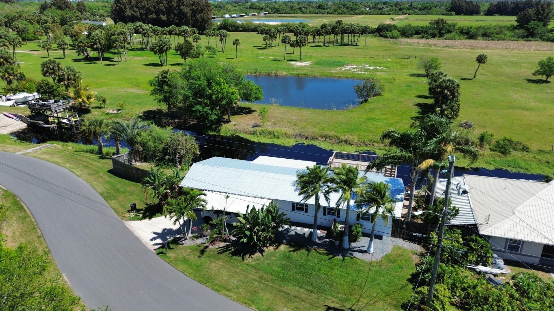 725 Mallard Road Cocoa, FL 32926 - Photo 1 of 37 an aerial view of a house with a yard and lake view