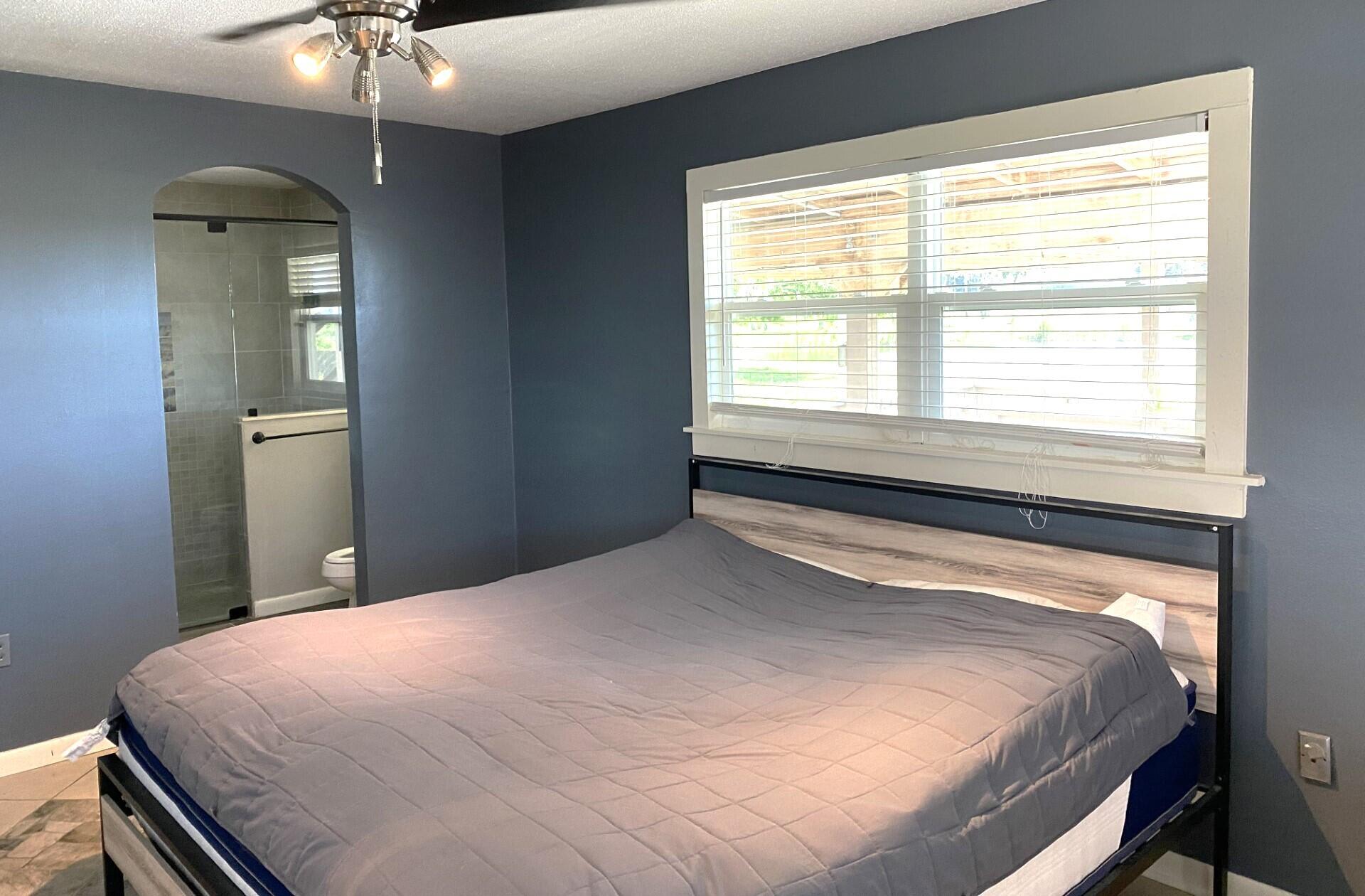 725 Mallard Road Cocoa, FL 32926 - Photo 17 of 37 a bedroom with a bed and a chandelier