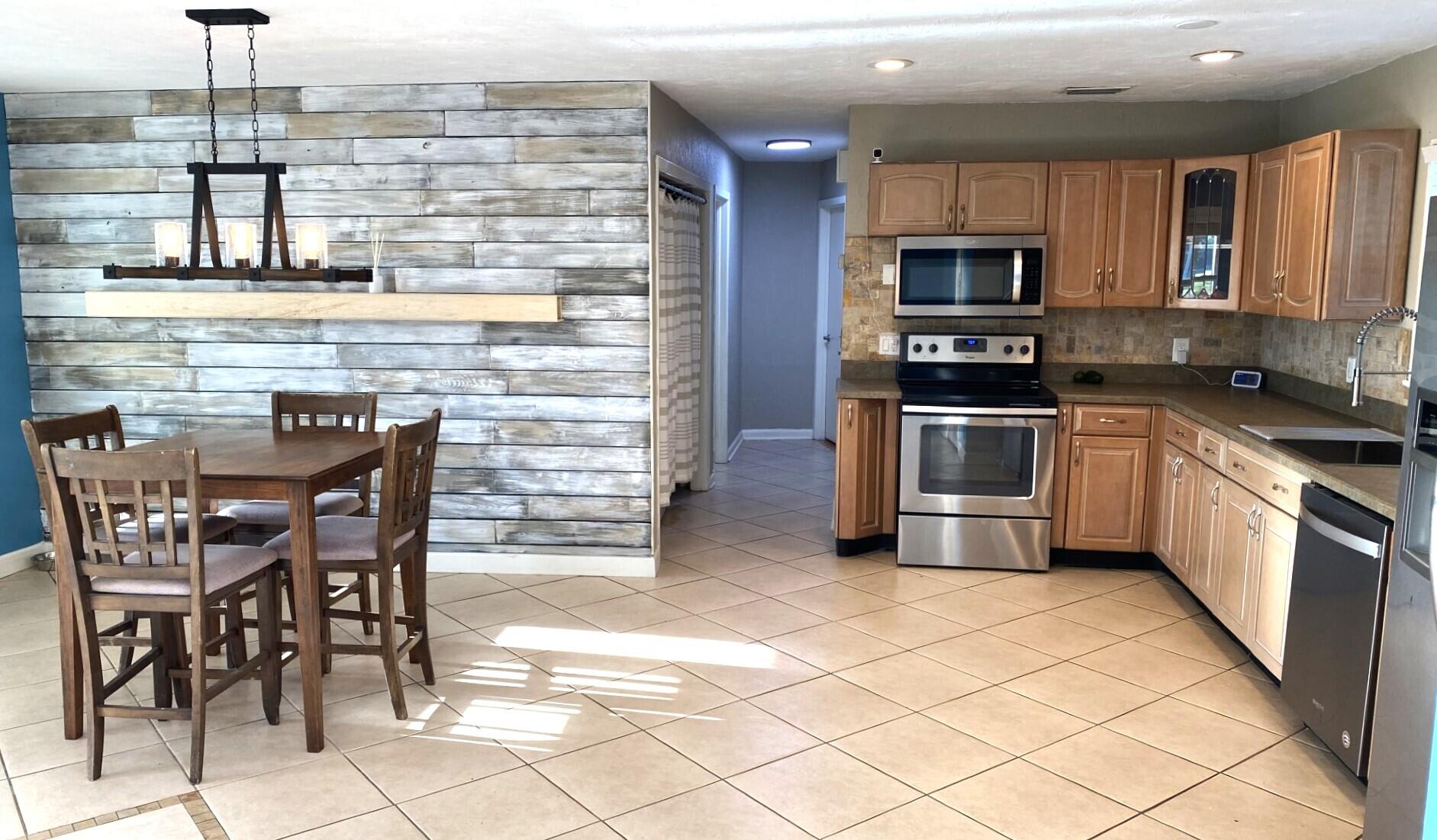 725 Mallard Road Cocoa, FL 32926 - Photo 23 of 37 a kitchen with stainless steel appliances kitchen island granite countertop a sink and cabinets