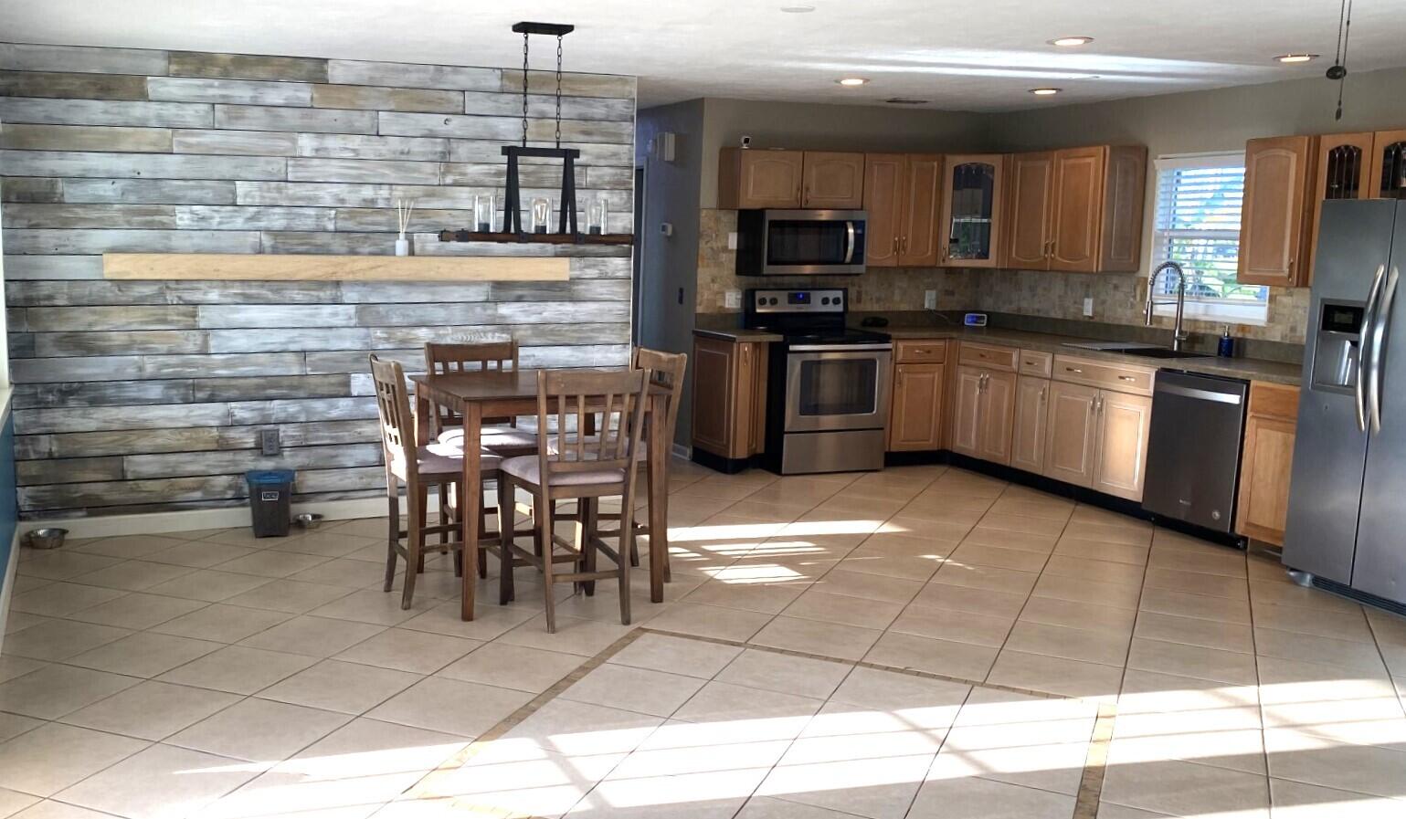 725 Mallard Road Cocoa, FL 32926 - Photo 29 of 37 a kitchen with stainless steel appliances kitchen island granite countertop a sink and cabinets