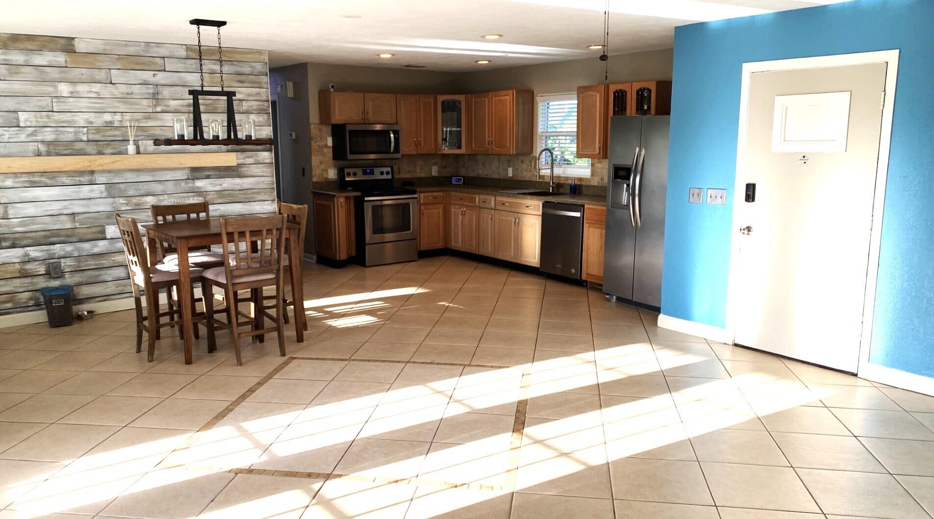 725 Mallard Road Cocoa, FL 32926 - Photo 30 of 37 a kitchen with stainless steel appliances kitchen island granite countertop a sink and cabinets