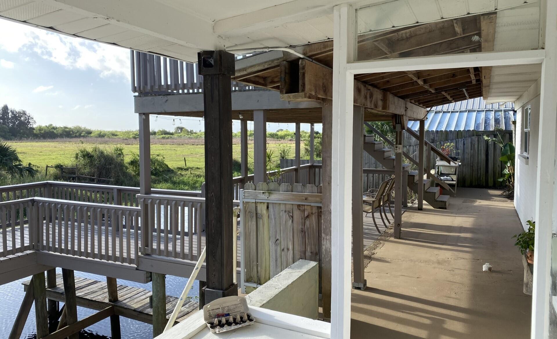 725 Mallard Road Cocoa, FL 32926 - Photo 5 of 37 a view of a balcony dining area and glass windows