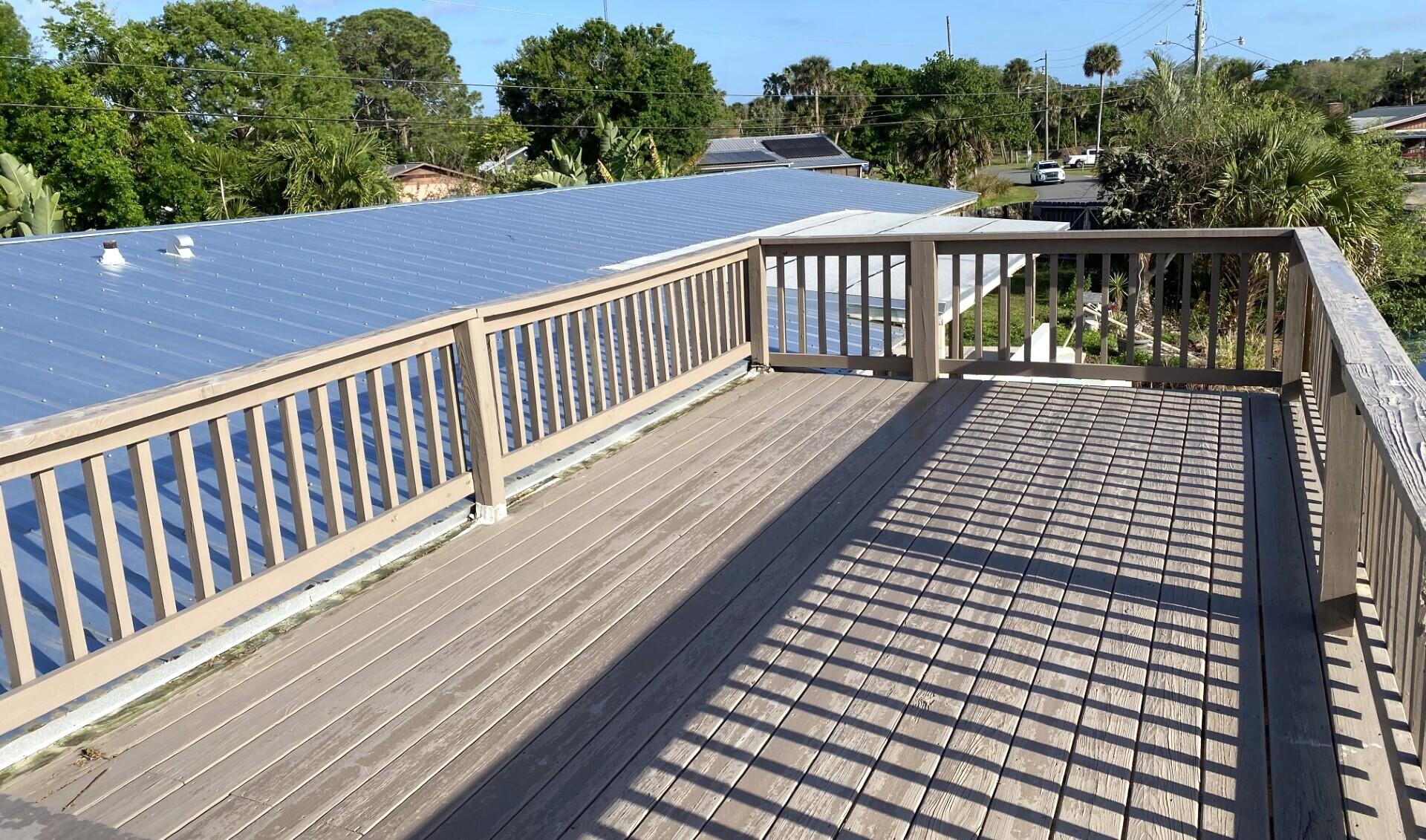 725 Mallard Road Cocoa, FL 32926 - Photo 7 of 37 a roof deck with wooden floor and fence