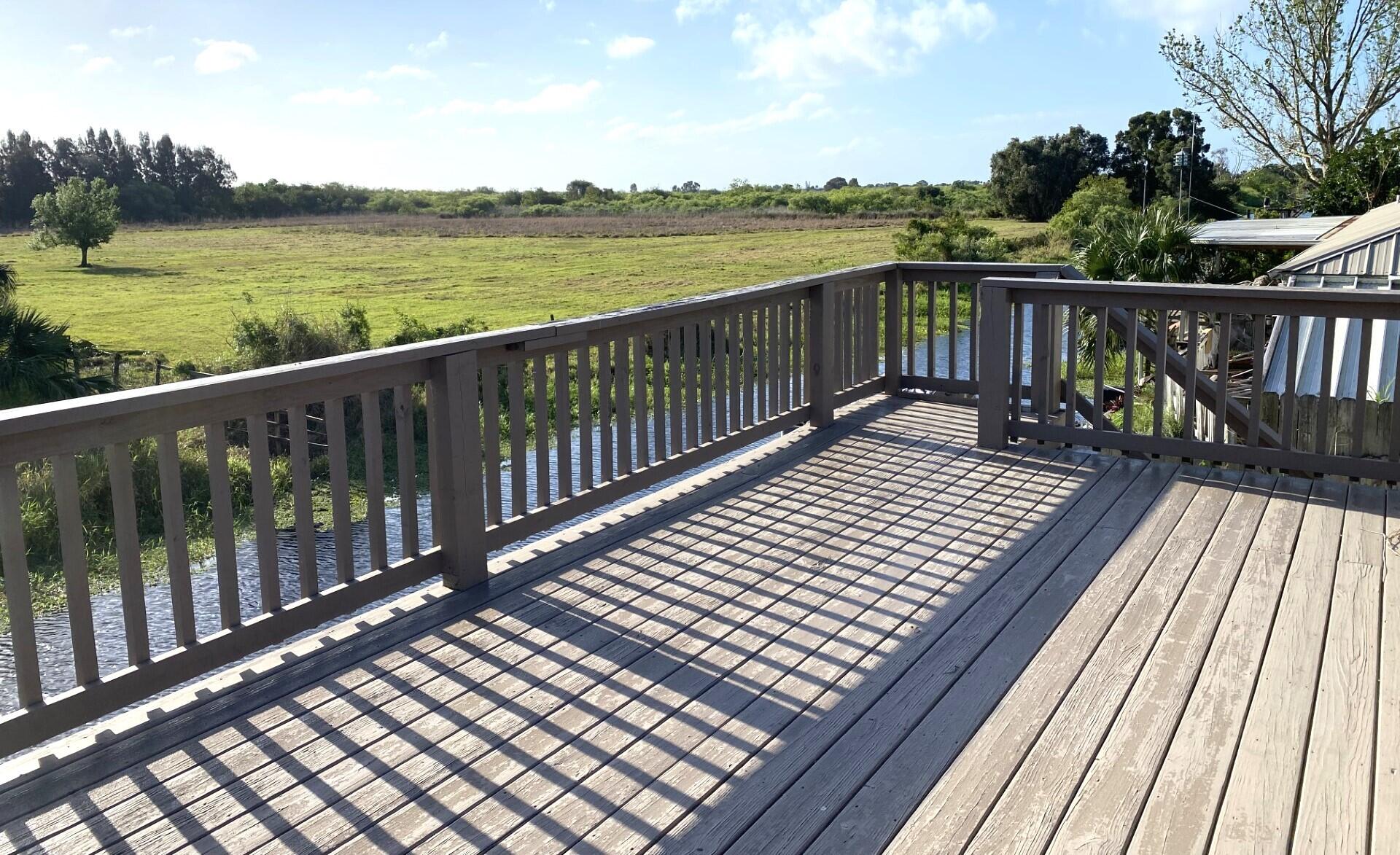 725 Mallard Road Cocoa, FL 32926 - Photo 8 of 37 a view of wooden deck with a lake view