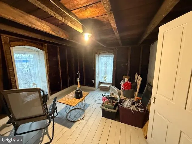 a living room with furniture and a mirror