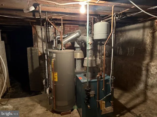 a room with water heater refrigerator