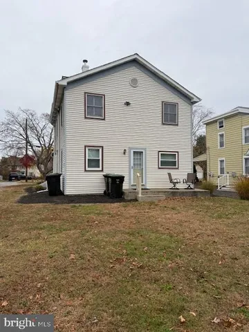 a front view of house with yard and trees