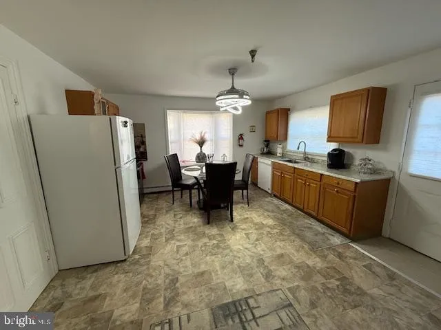 a kitchen with refrigerator and cabinets