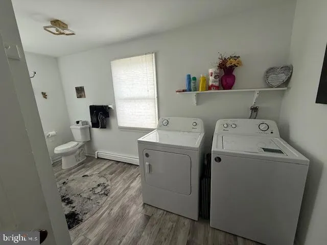 a view of a storage and utility room with a washer dryer