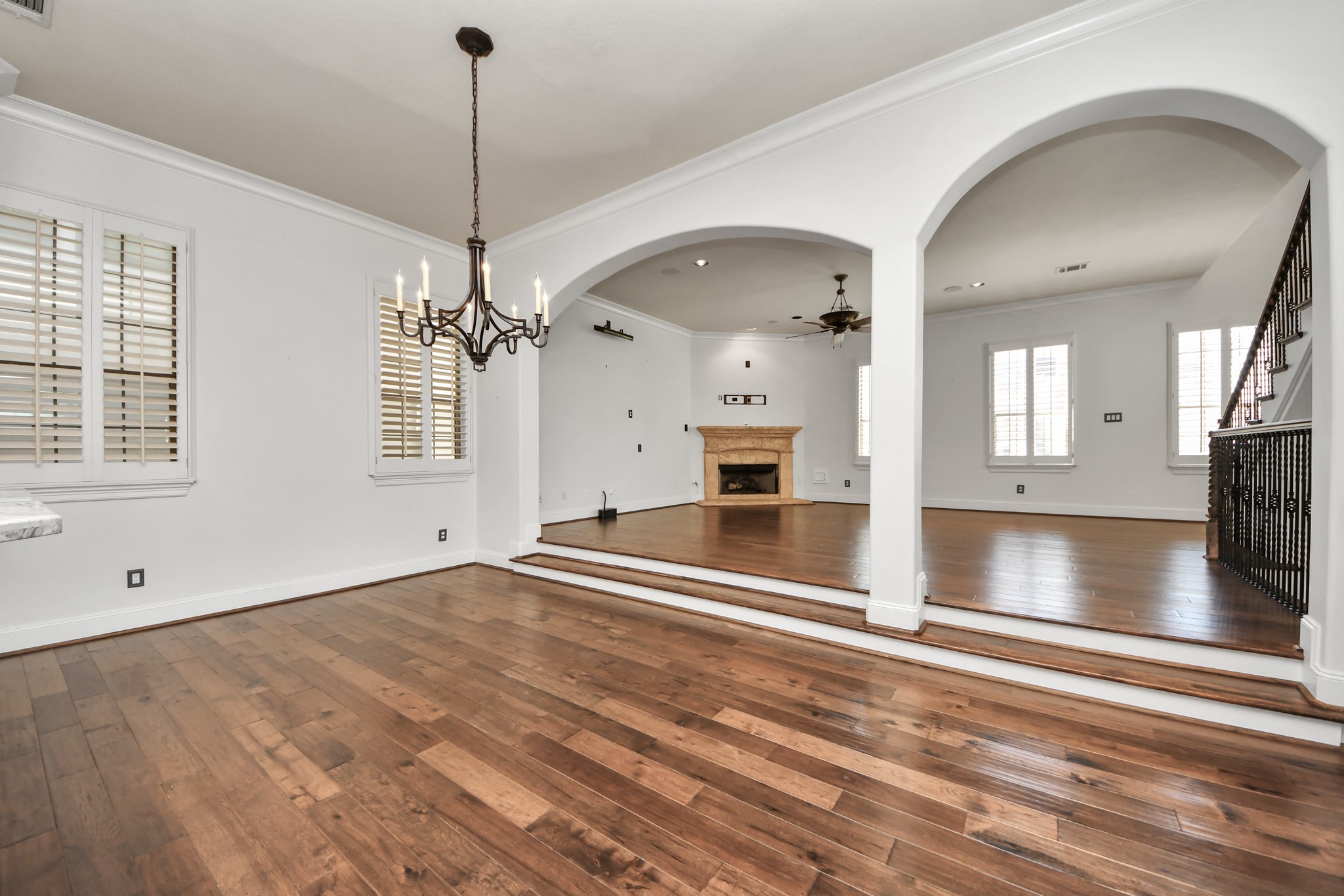 710 Jackson Hill Street Houston, TX 77007 - Photo 14 of 31 This spacious living area features elegant hardwood floors, a cozy fireplace, and large windows with shutters for natural light.