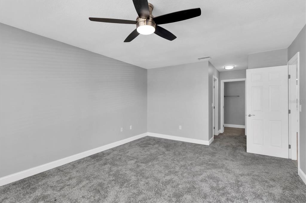 5925 Seaside Drive New Port Richey, FL 34652 - Photo 17 of 55 an empty room with chandelier fan