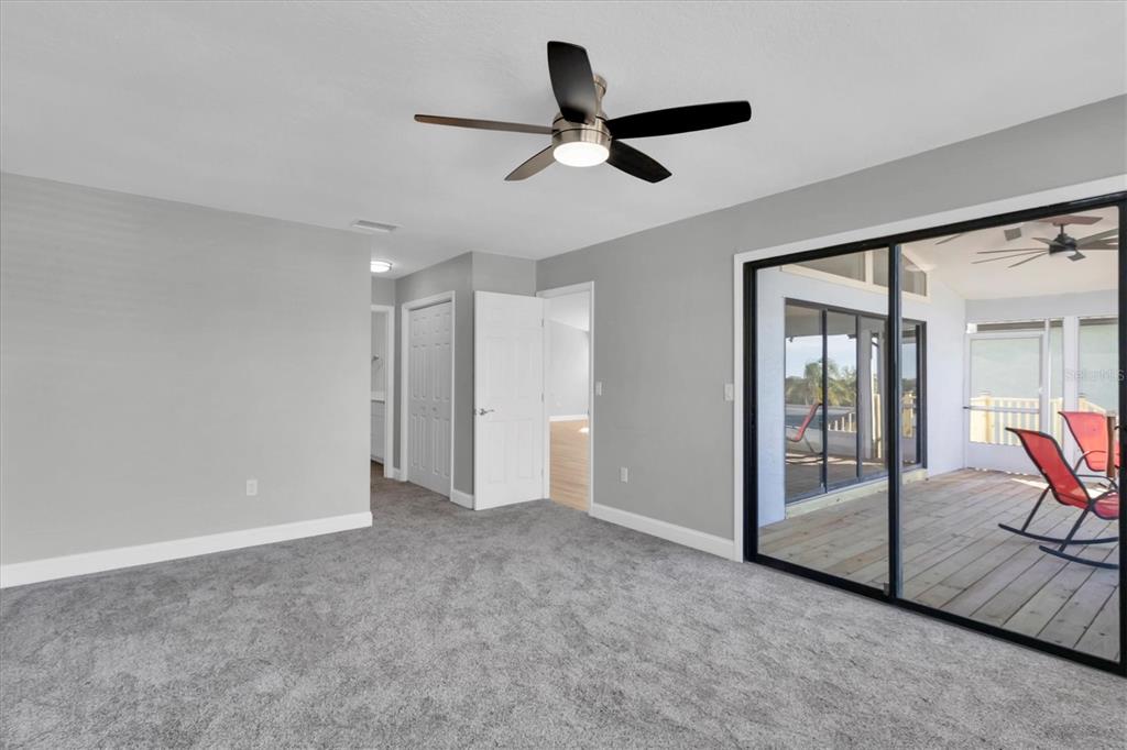 5925 Seaside Drive New Port Richey, FL 34652 - Photo 18 of 55 a view of an empty room with a ceiling fan