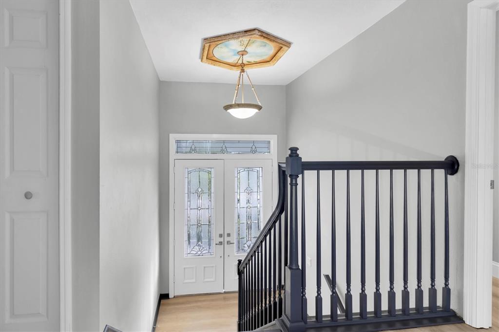 5925 Seaside Drive New Port Richey, FL 34652 - Photo 3 of 55 a view of a hallway with wooden floor and staircase