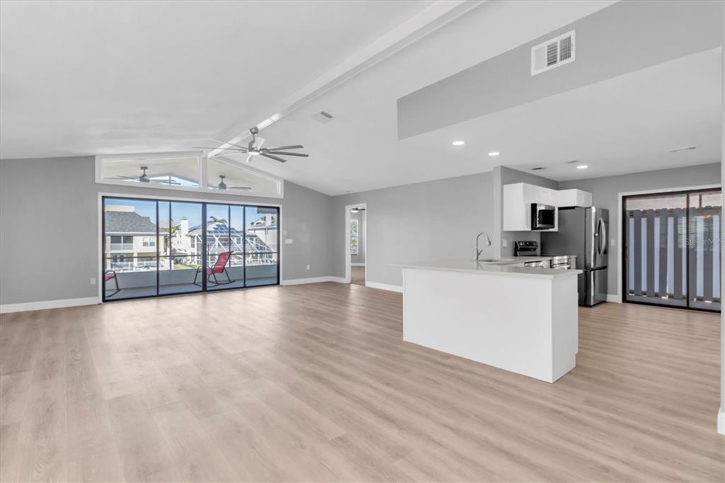 5925 Seaside Drive New Port Richey, FL 34652 - Photo 5 of 55 a view of an empty room with wooden floor and a window