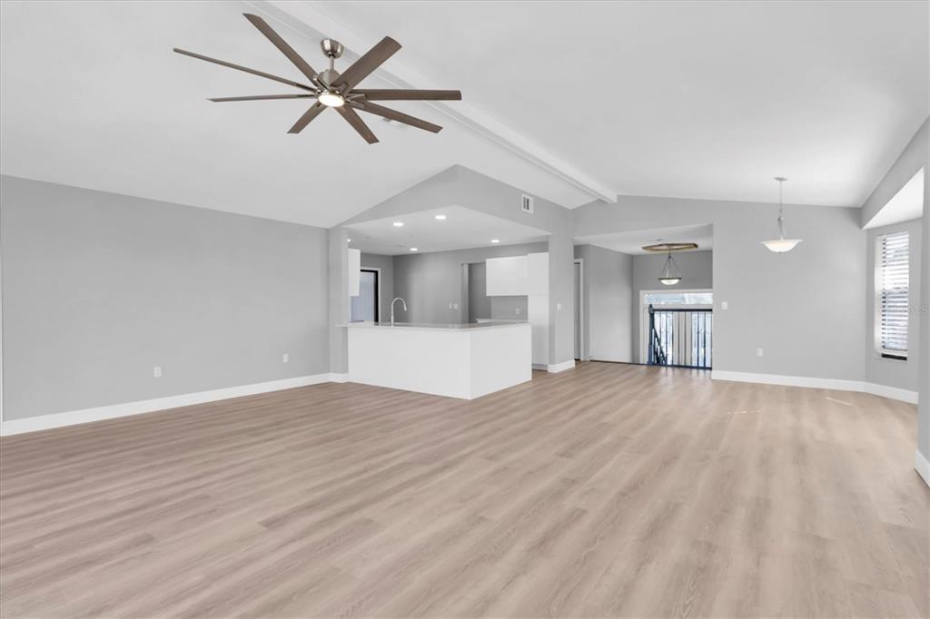 5925 Seaside Drive New Port Richey, FL 34652 - Photo 6 of 55 a view of empty room with wooden floor and ceiling fan