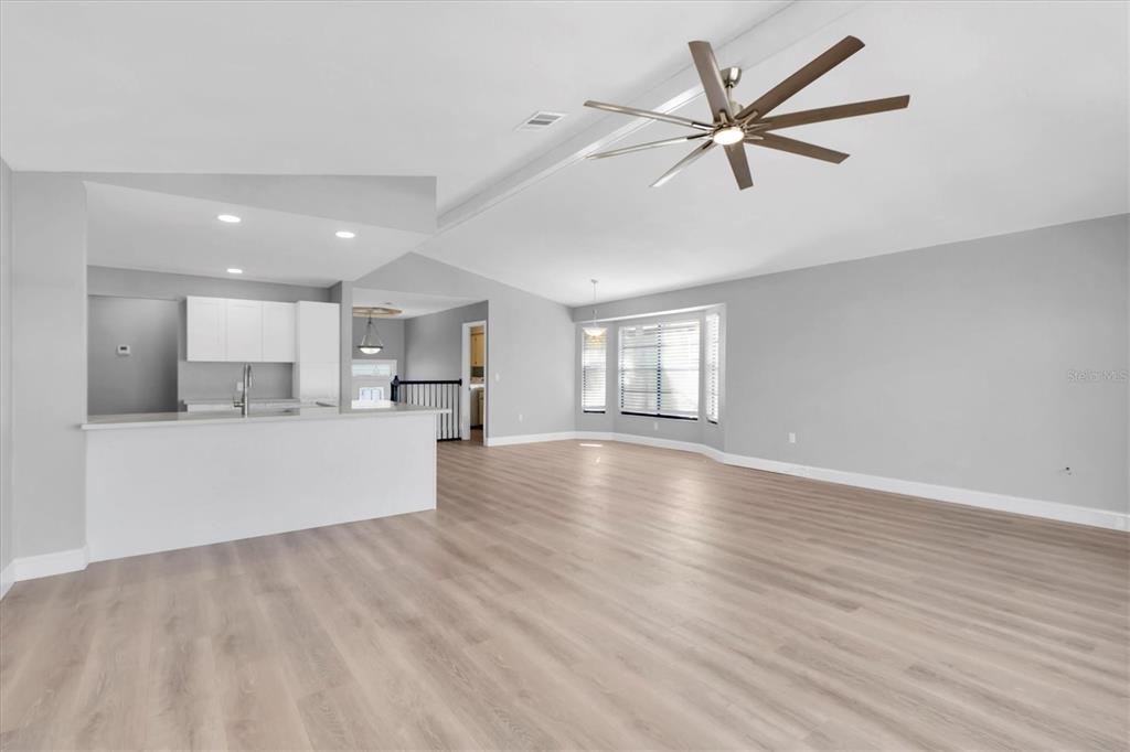 5925 Seaside Drive New Port Richey, FL 34652 - Photo 7 of 55 a view of empty room with wooden floor and window