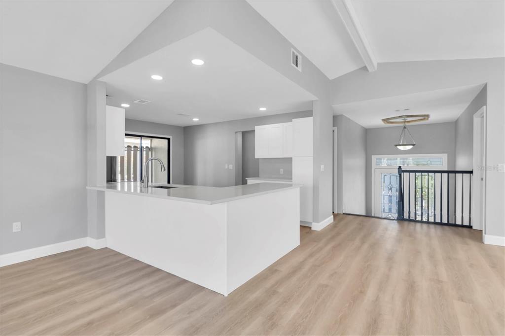 5925 Seaside Drive New Port Richey, FL 34652 - Photo 10 of 55 a view of a big room with wooden floor and windows