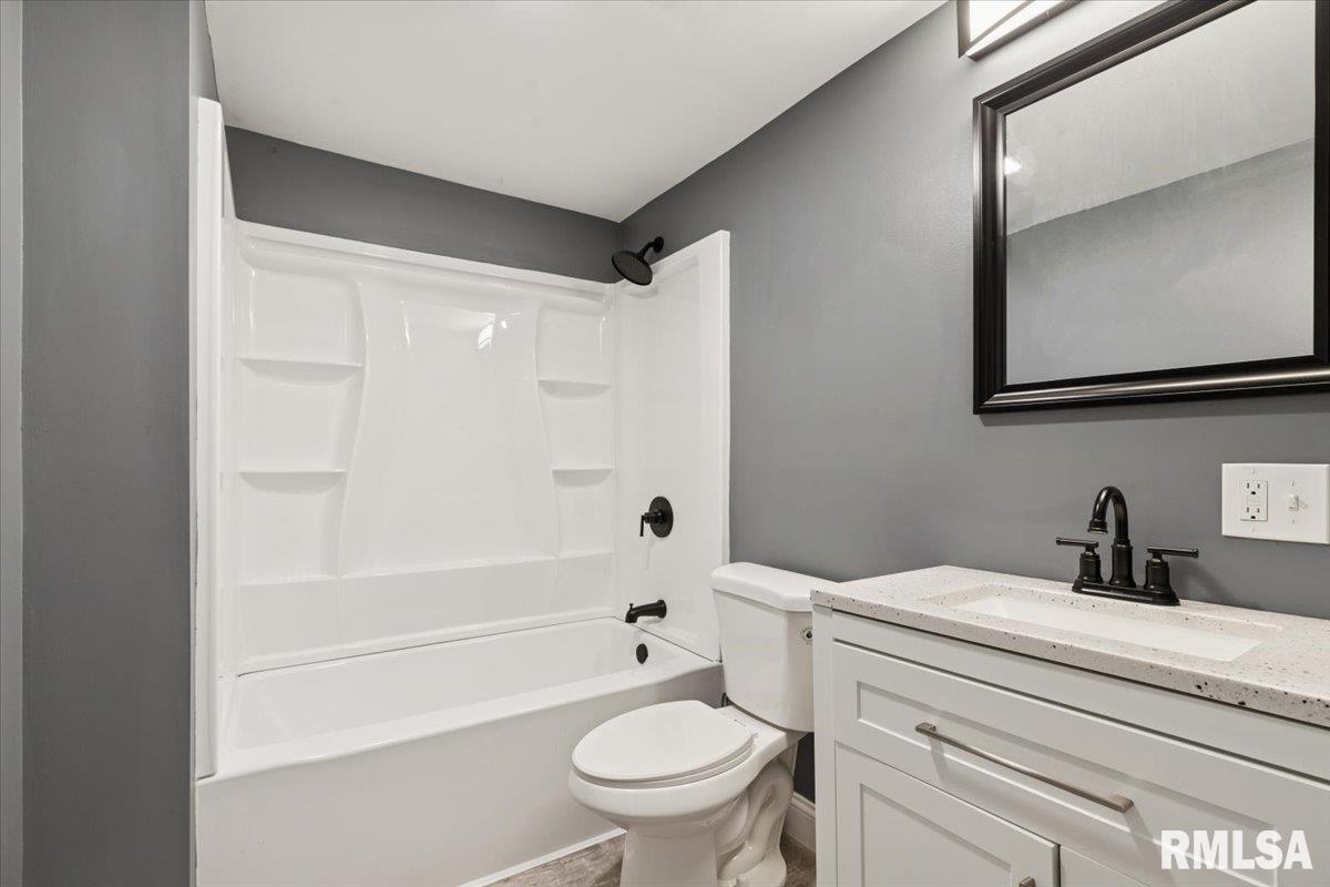 3312 Garfield Street Clinton, IA 52732 - Photo 15 of 31 a bathroom with a sink a toilet and a bathtub