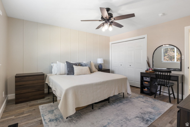 415 360 East Salem, UT 84653 - Photo 8 of 20 Accent wall with vertical paneling, light wood-finish flooring, ceiling fan with integrated lighting, window with natural light, and bi-fold closet doors