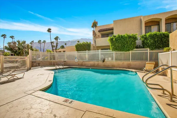 a view of a backyard with swimming pool