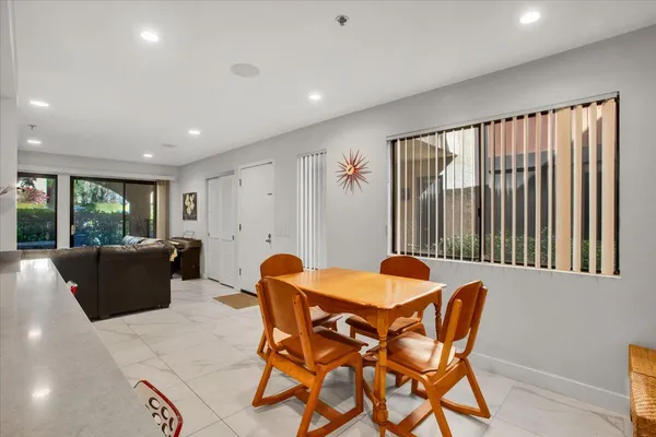 a view of a dining room with furniture and a window