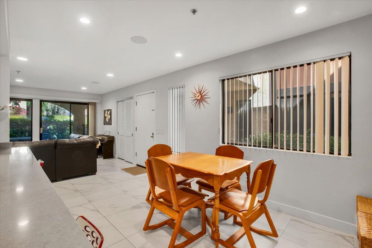 200 East Racquet Club Road, Unit 31 Palm Springs, CA 92262 - Photo 11 of 49 a view of a dining room with furniture and a window