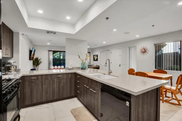 a kitchen with a sink refrigerator and cabinets