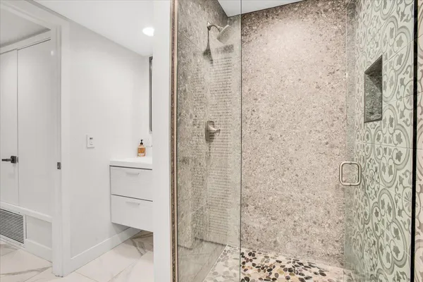 a bathroom with a shower and a sink