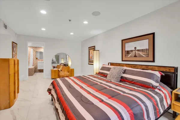 a bedroom with double bed and a large mirror