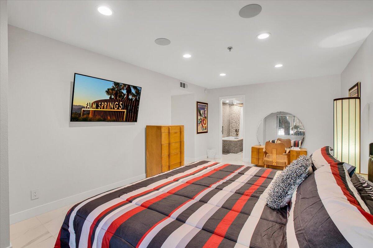 200 East Racquet Club Road, Unit 31 Palm Springs, CA 92262 - Photo 25 of 49 a bedroom with a bed and a painting on the wall
