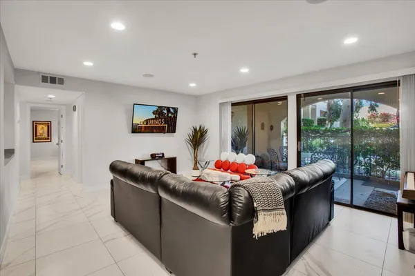 a living room with furniture and large windows