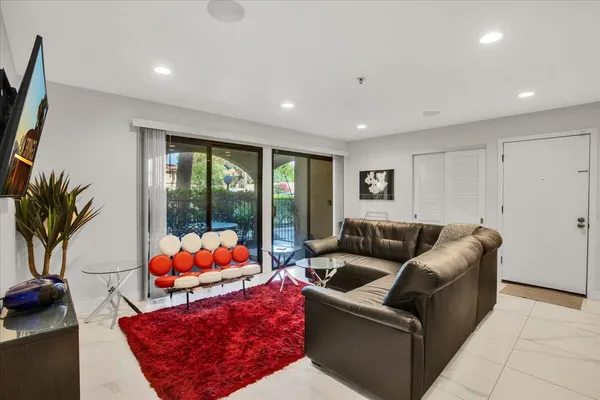 a living room with furniture and a large window