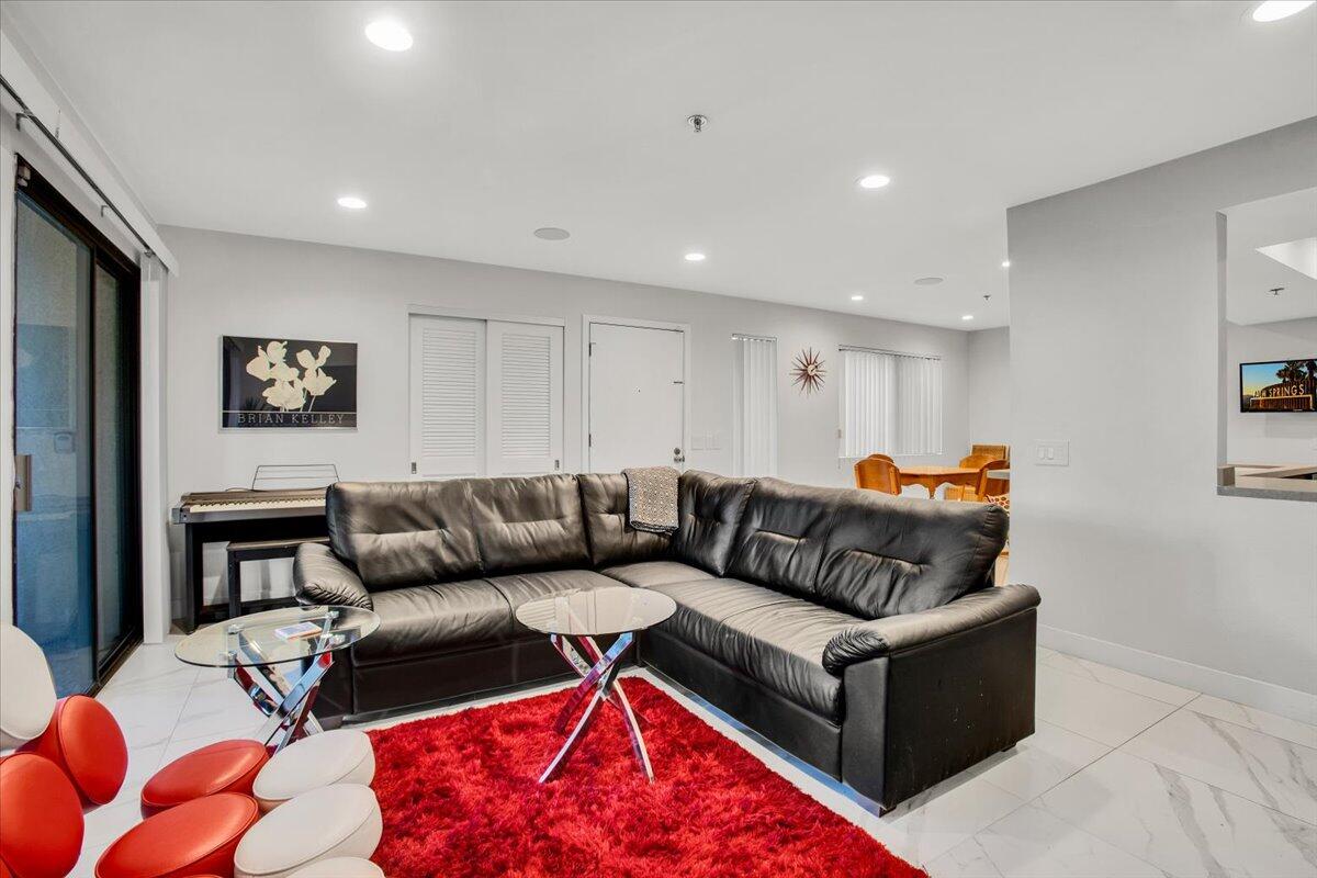 200 East Racquet Club Road, Unit 31 Palm Springs, CA 92262 - Photo 8 of 49 a living room with furniture and a couch