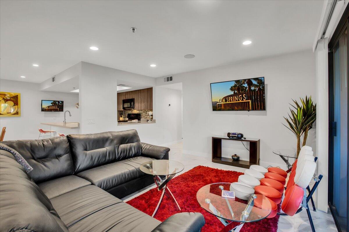 200 East Racquet Club Road, Unit 31 Palm Springs, CA 92262 - Photo 9 of 49 a living room with furniture and a flat screen tv