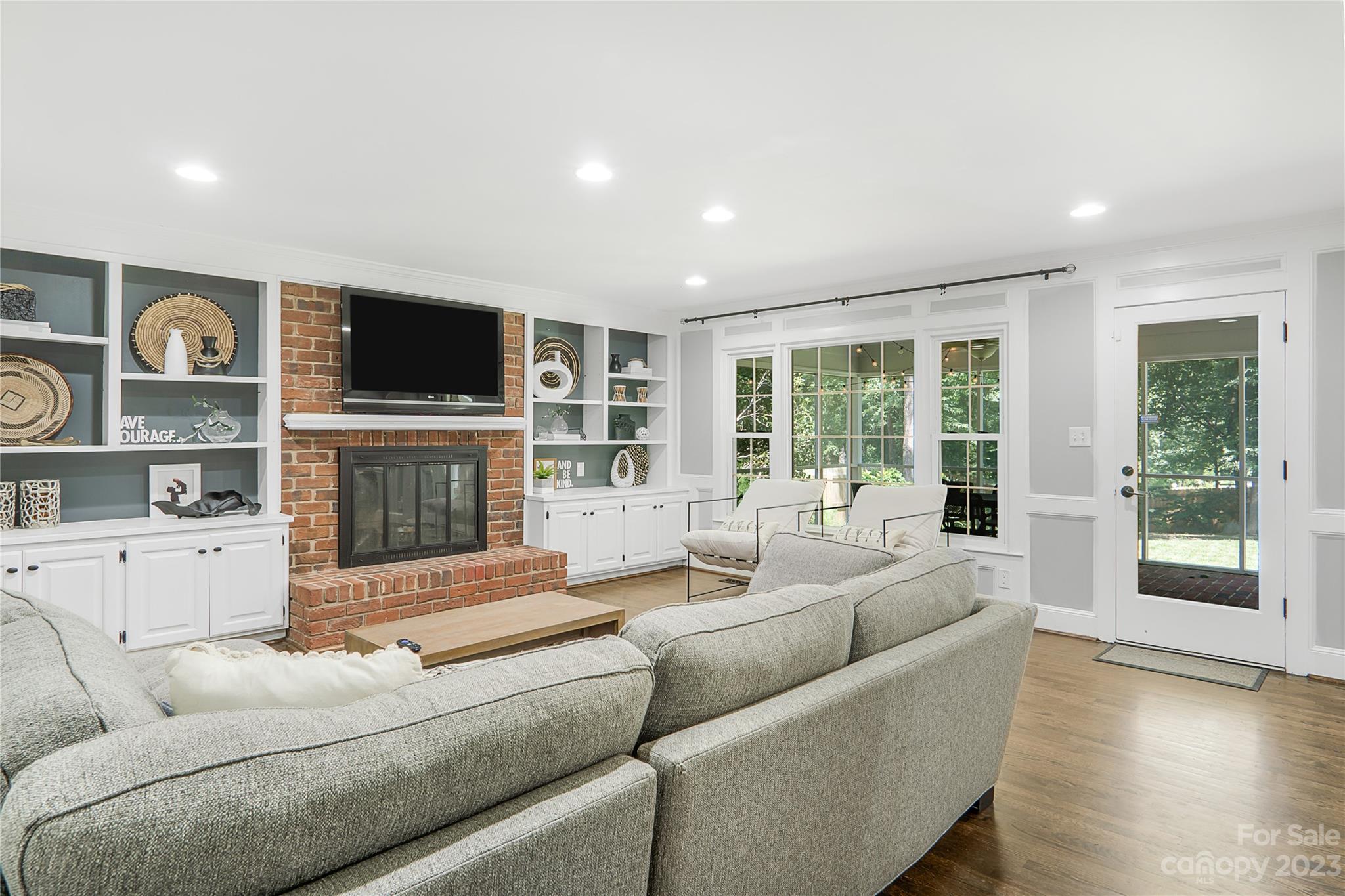 4339 Quail View Road Charlotte, NC 28226 - Photo 13 of 40 a living room with furniture a flat screen tv and a fireplace